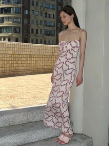 Detailed full-length view of a slim-fit white floral maxi dress with purple heart patterns