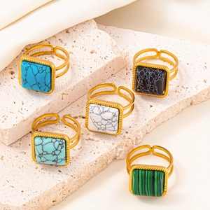 Adjustable gold stainless steel ring set with square colorful marble gemstones on stone base