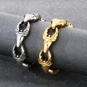 Macro detail of punk rock crab claw links in vacuum-plated gold and silver titanium steel