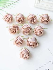 Top view of ten pink-purple artificial silk rose heads with realistic petals for DIY crafts