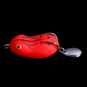Macro detail of red hollow body frog lure with sharp double hooks and metal spinner blade