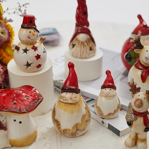Ceramic Christmas figurines featuring Santa, snowman and elk with warm festive lighting