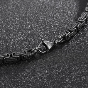 Detail of vintage black stainless steel chain link with secure lobster clasp closure
