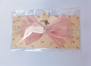 Close-up of baby headband with pink mesh bow and sparkling crown rhinestone detail
