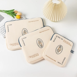 Three-piece set of off-white laptop sleeves with blue zippers and embroidered logos