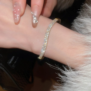 Close-up of luxury 18k gold plated bracelet with double-row sparkling zircon crystals