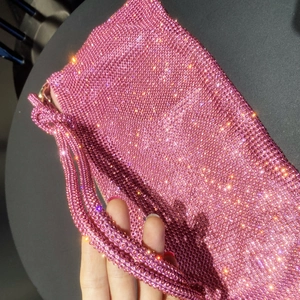 Macro detail of high-quality pink rhinestones on a sparkling luxury handbag
