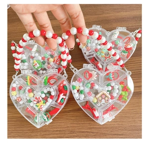 Detail of heart-shaped Christmas gift box with beaded handle and festive hair accessories