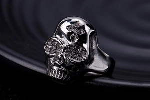 Detail of gothic skull ring with cross engraving and sparkling cubic zirconia eyes