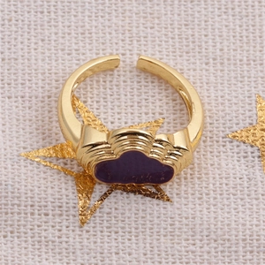 Macro view of gold cloud ring with purple enamel inlay and adjustable open band