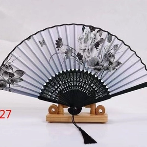 Japanese style folding fan with black ink floral patterns and decorative silk tassel