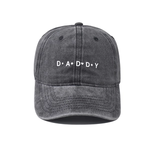 Detailed embroidery of DADDY text and poker suits on washed black cotton baseball cap