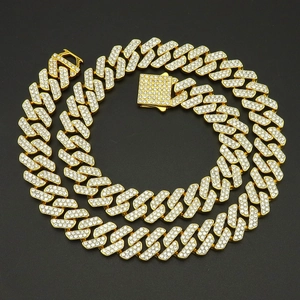 Macro shot of gold-plated Cuban link necklace with iced-out crystals and square box clasp