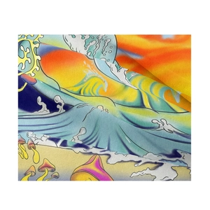 Close-up of vibrant mushroom print and psychedelic wave patterns on fabric tapestry