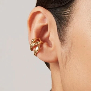 Minimalist gold ear cuff in stainless steel shown on model for a modern geometric look