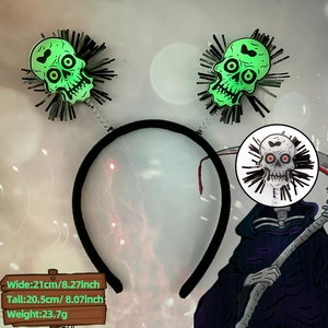 Halloween headband with green glowing skulls and black tassels on vibrating springs