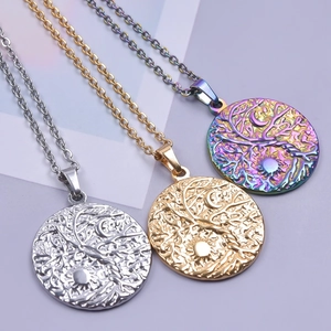 Detailed view of sun and moon tree of life pendants in silver, gold, and rainbow finish