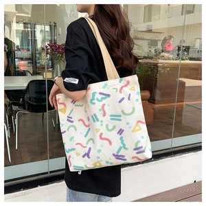 Detail of large capacity canvas bag with colorful geometric abstract prints for women