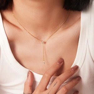 Minimalist 18K gold Y-shaped stainless steel necklace with crystal drops worn by model