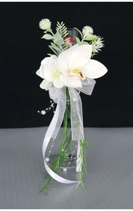 Close-up of white cymbidium orchid wedding glass flower with ribbon and pearls