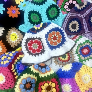 Handmade crochet bucket hats with colorful hollow-out floral patterns and sun flower knit detail