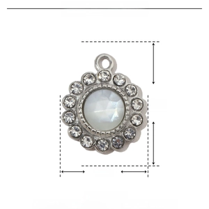 Detail of 14mm silver flower pendant featuring shell inlay and rhinestone accents