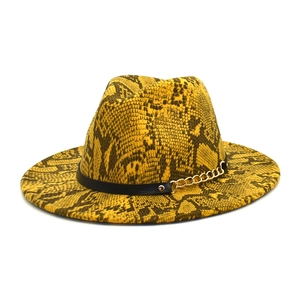 Yellow snake skin print fedora hat with gold chain detail and black leather band décor