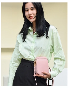 Pink multi-zipper canvas crossbody phone bag shown with model in casual outfit