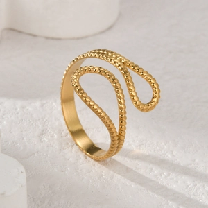 Macro shot of 14K gold-plated C-shaped open ring with intricate twisted rope texture