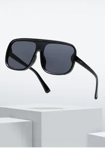 Detail of black oversized one-piece fashion sunglasses with sleek frame and dark lenses