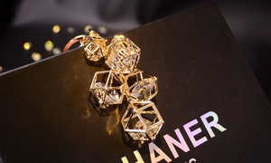 Macro shot of gold geometric hollow frames with clear faceted crystals and metal rings