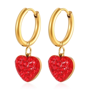 Gold hoop earrings featuring sparkling red crystal heart pendants on white background