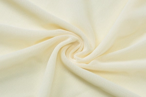 Macro detail of breathable mesh knit fabric in cream white with soft texture and drape