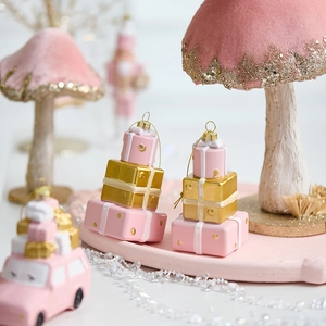 Pink Christmas ornaments collection featuring stacked gift boxes and velvet mushrooms