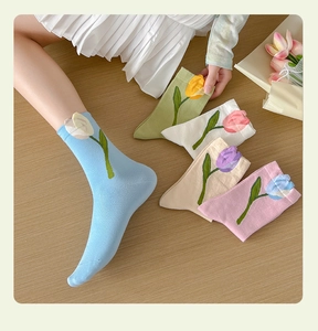 Detailed view of combed cotton crew socks with exquisite tulip embroidery in soft pastel colors