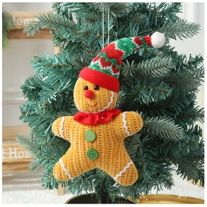 Gingerbread man ornament with corduroy texture and knit hat on Christmas tree branch