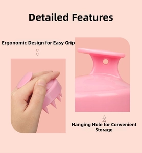 Detailed view of pink hair massage brush with ergonomic handle and convenient hanging hole