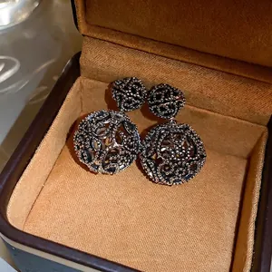 Vintage hollow sphere silver stud earrings with intricate beaded patterns and matte finish