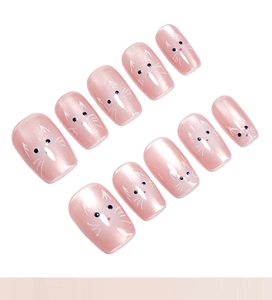 Close-up of pink cat eye short press-on nails with cute cat face patterns in 10-piece set
