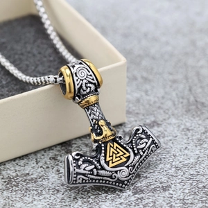 Detail of a dual-tone Viking Mjolnir pendant in a premium gift box with box chain