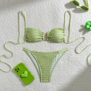 Light green textured bikini set featuring gold U-shaped hardware and side cutout details