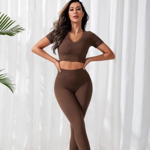 Seamless brown ribbed knit yoga set featuring a V-neck short sleeve crop top and high waist leggings