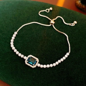 Macro view of adjustable bolo bracelet with blue rectangular zircon and silver plating