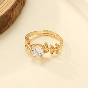 Close-up of laurel leaf branch open ring with one carat round cut moissanite diamond
