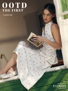 Floral satin halter top and long bubble skirt set shown in a cozy indoor window setting