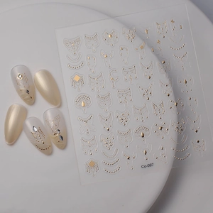 Macro shot of 5D gold embossed nail stickers with Co-097 geometric and celestial patterns