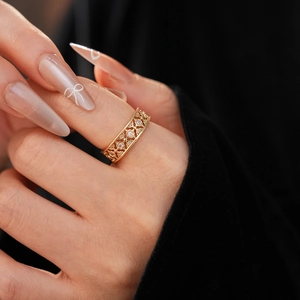 Macro shot of a gold-plated flower ring with zircon inlays and hollow carved details
