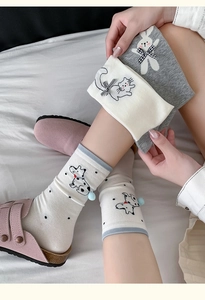 Detail showing knit cotton socks with 3D bows and cute embroidered animal faces