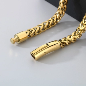 Detailed close-up of 6mm golden stainless steel spring clasp and curb link chain texture
