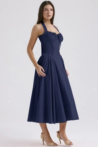 Detail of navy blue halter dress with corset bodice and pleated flowy skirt